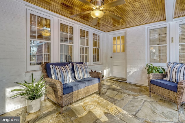 sunroom with ceiling fan and wood ceiling