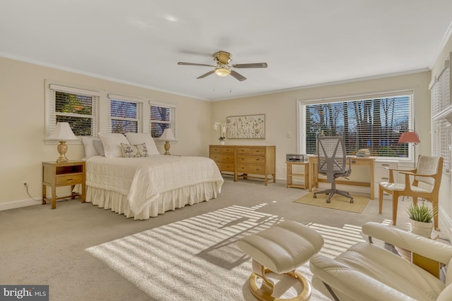 carpeted bedroom with ornamental molding and ceiling fan