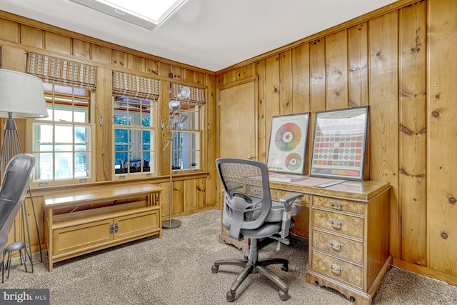 carpeted office with ornamental molding and wooden walls