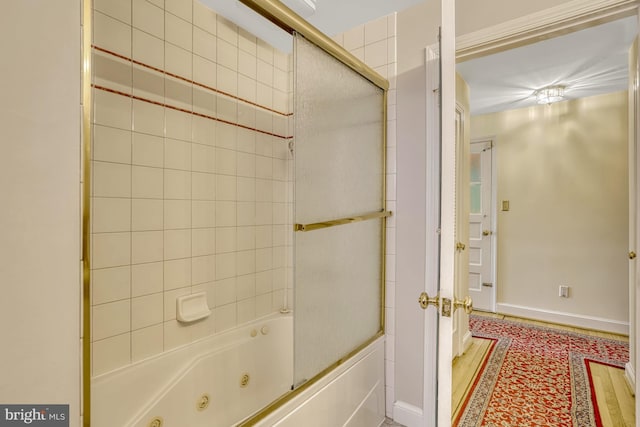 bathroom featuring bath / shower combo with glass door