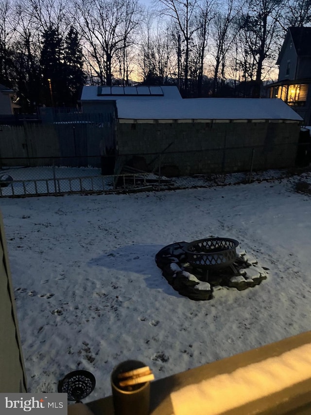 yard covered in snow featuring a fire pit