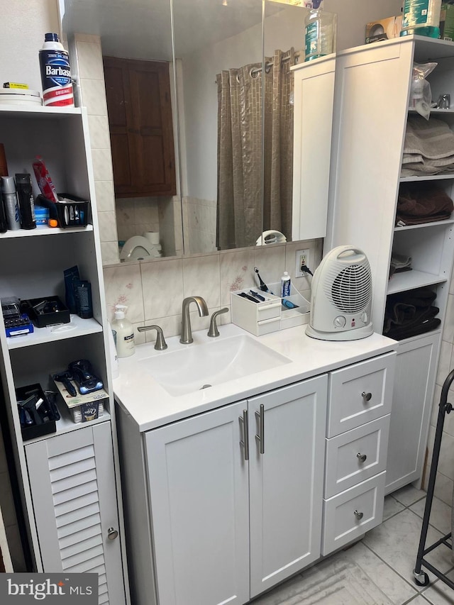 bathroom featuring vanity, tasteful backsplash, and tile patterned floors