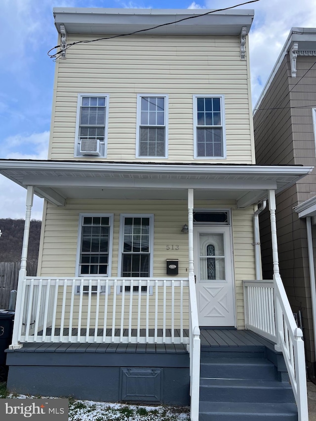 view of front facade featuring covered porch and cooling unit