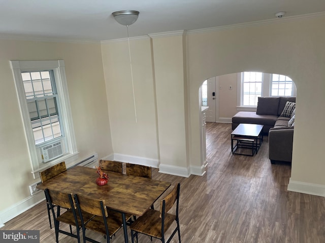 dining space with dark hardwood / wood-style floors and ornamental molding