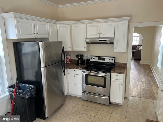 kitchen with white cabinetry, crown molding, light tile patterned floors, and stainless steel appliances