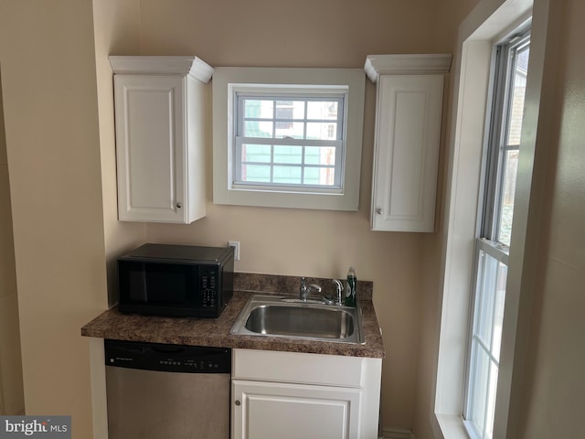 kitchen featuring white cabinetry, sink, and stainless steel dishwasher