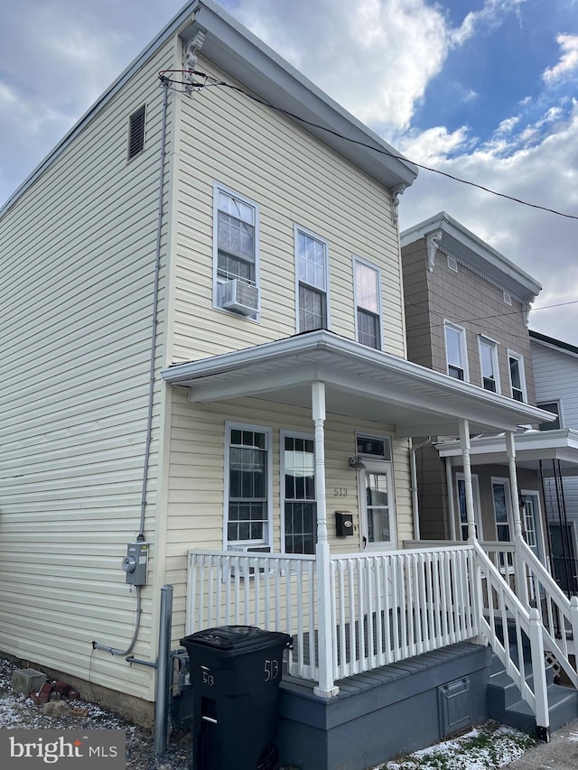 view of front of house with a porch and cooling unit