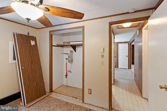 interior space with ceiling fan, crown molding, and a closet