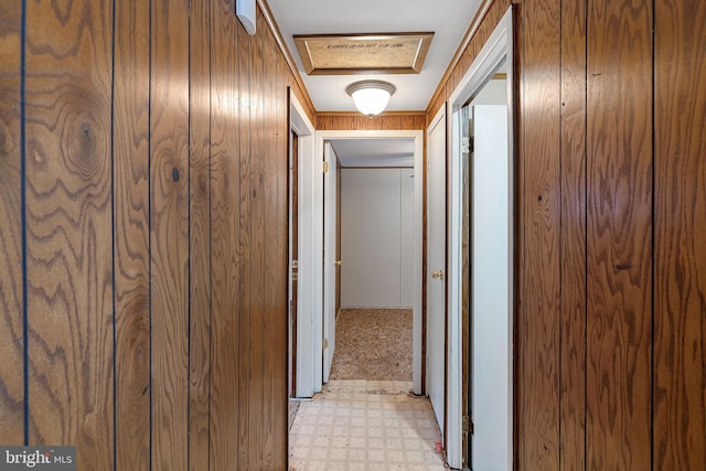 hallway with wood walls