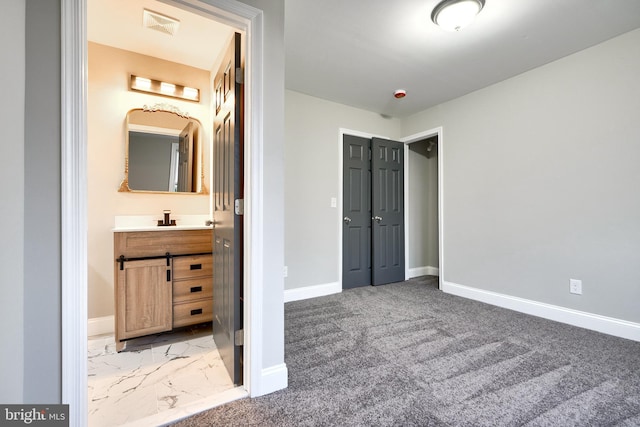 unfurnished bedroom with carpet and sink