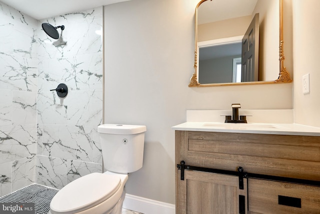 bathroom with vanity, toilet, and tiled shower