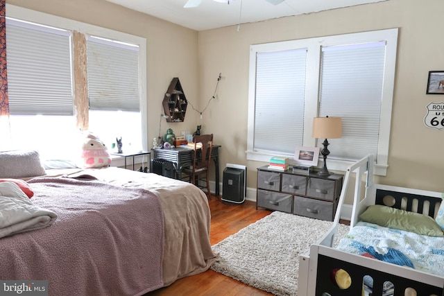 bedroom with ceiling fan and hardwood / wood-style floors