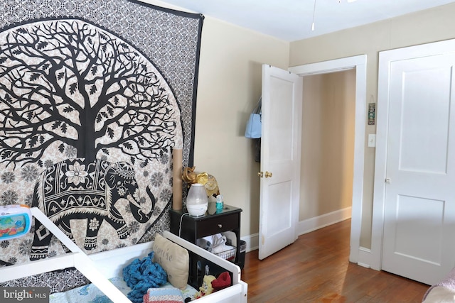 bedroom with dark wood-type flooring