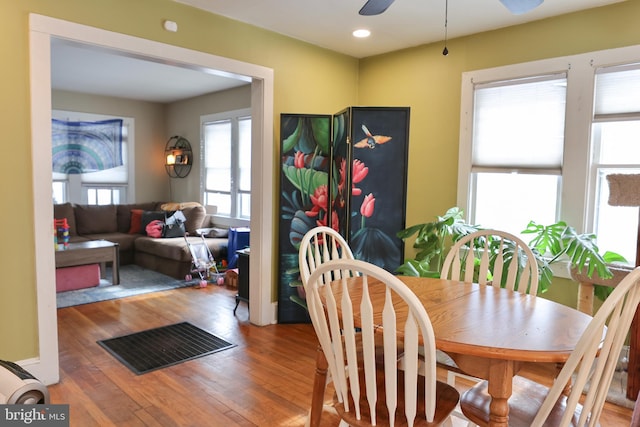 dining room with ceiling fan, a healthy amount of sunlight, and hardwood / wood-style floors