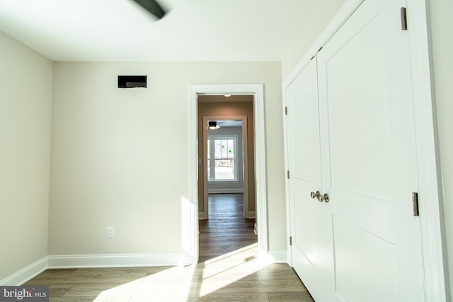 unfurnished bedroom featuring hardwood / wood-style flooring and a closet