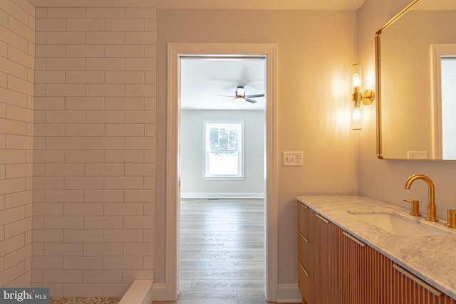 bathroom featuring a shower, wood-type flooring, vanity, and ceiling fan