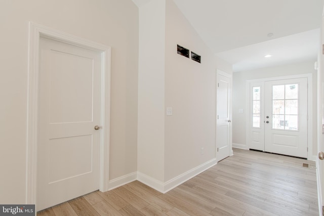 entrance foyer with light hardwood / wood-style flooring and lofted ceiling