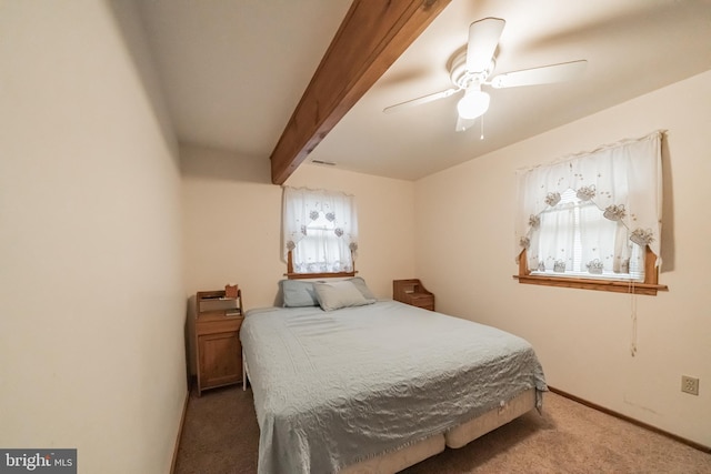 bedroom with ceiling fan, beam ceiling, and carpet flooring