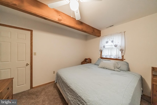 bedroom featuring ceiling fan, beam ceiling, and carpet floors