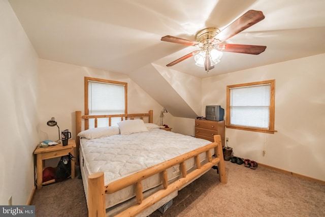 carpeted bedroom with ceiling fan and vaulted ceiling