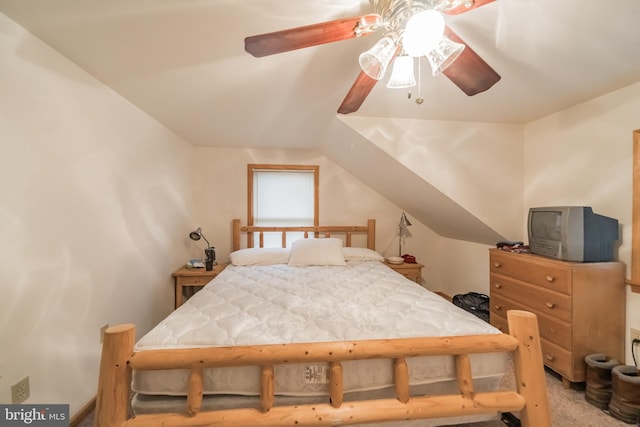 carpeted bedroom with ceiling fan and vaulted ceiling