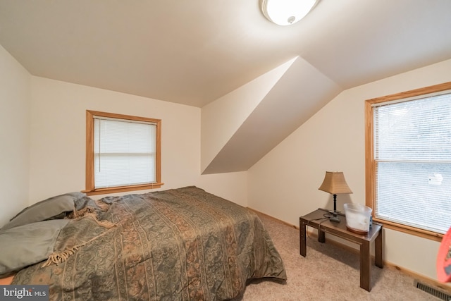 bedroom with light carpet and vaulted ceiling