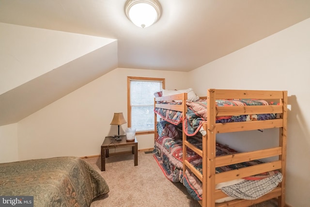 bedroom featuring carpet flooring and lofted ceiling