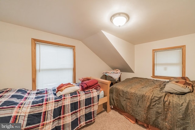 carpeted bedroom featuring vaulted ceiling