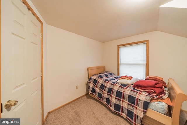 carpeted bedroom featuring lofted ceiling