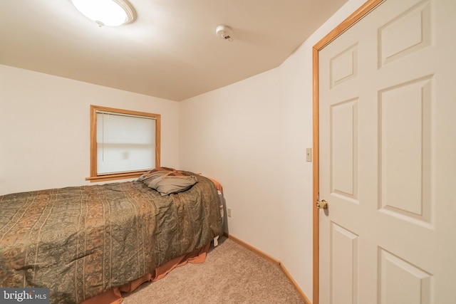 bedroom featuring light colored carpet