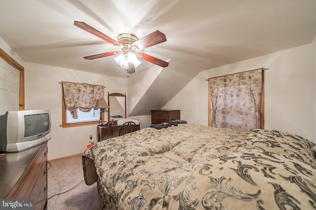 bedroom with ceiling fan, light carpet, and vaulted ceiling