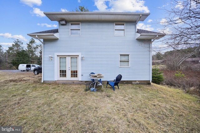 back of house with french doors and a yard