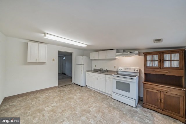 kitchen featuring sink, white appliances, and white cabinets