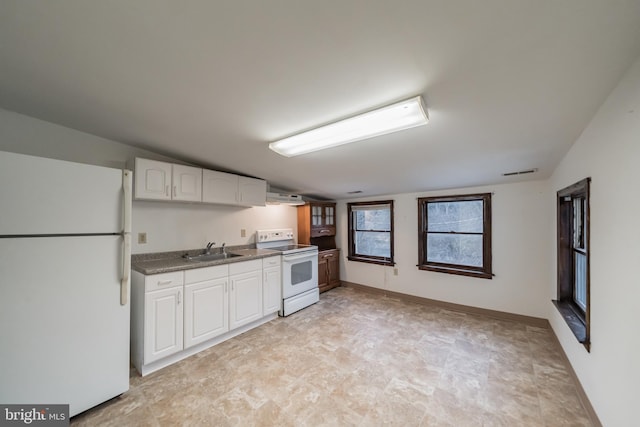 kitchen featuring sink, white appliances, and white cabinets