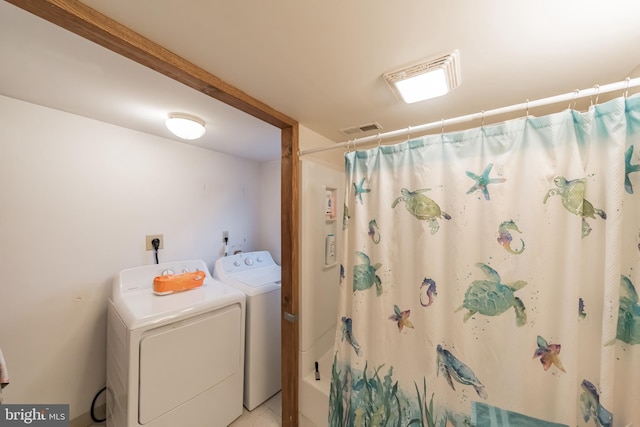 bathroom with shower / tub combo with curtain and separate washer and dryer