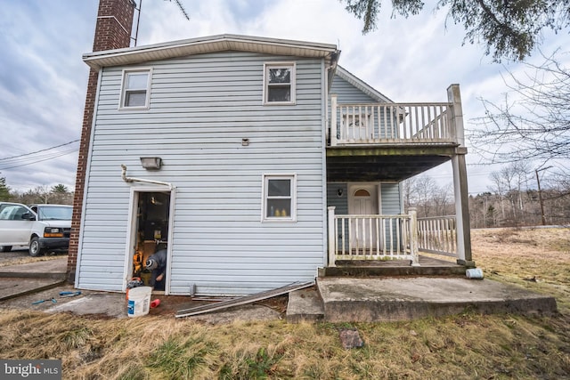 back of property with a porch