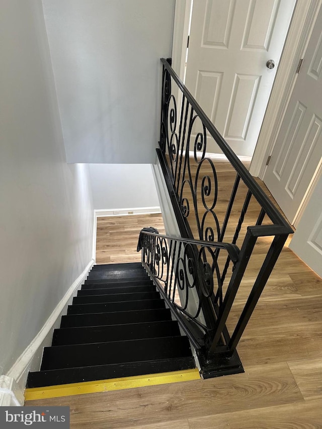 stairway featuring hardwood / wood-style floors