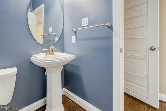 bathroom featuring hardwood / wood-style floors and toilet