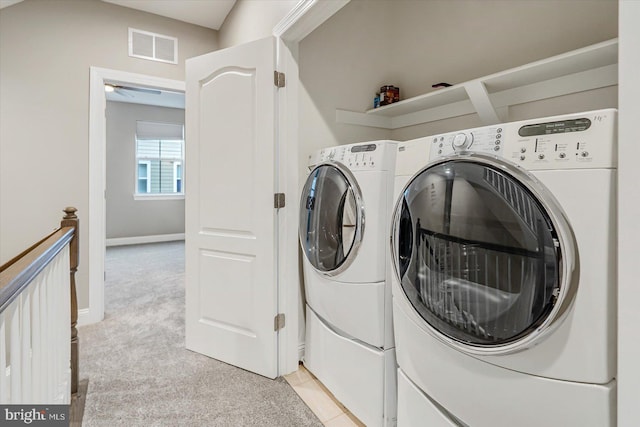 washroom featuring light colored carpet and washer and dryer