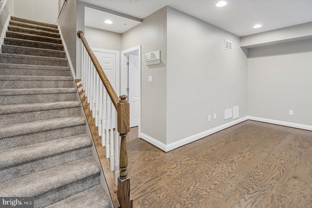 stairway featuring hardwood / wood-style flooring