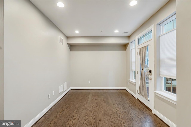 empty room featuring dark hardwood / wood-style flooring