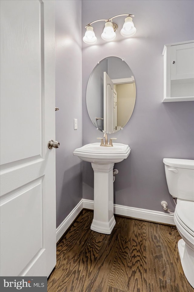 bathroom with wood-type flooring and toilet