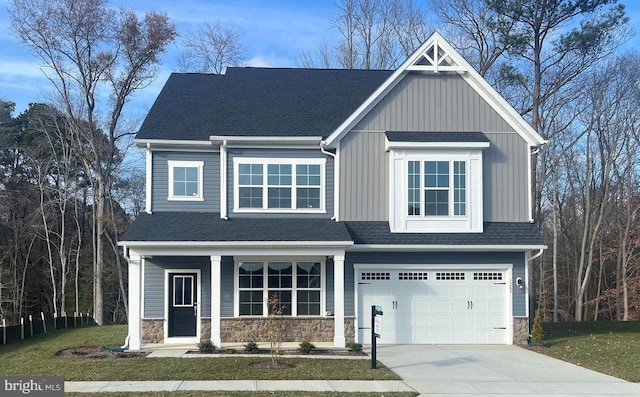 craftsman-style home with a front yard and a garage