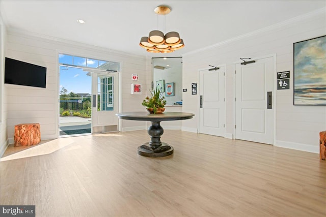 entryway with wood-type flooring and ornamental molding