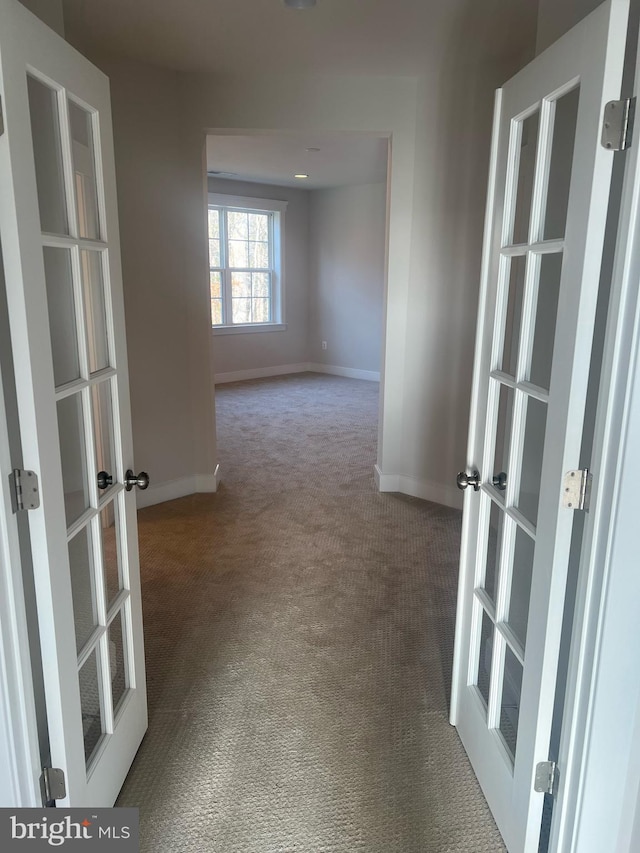 corridor with carpet flooring and french doors