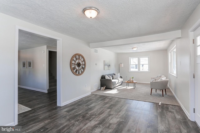 unfurnished room featuring dark hardwood / wood-style flooring and a textured ceiling