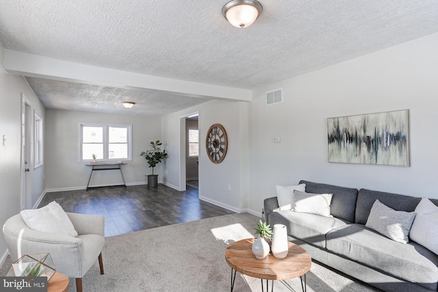 living room featuring dark hardwood / wood-style floors and a textured ceiling