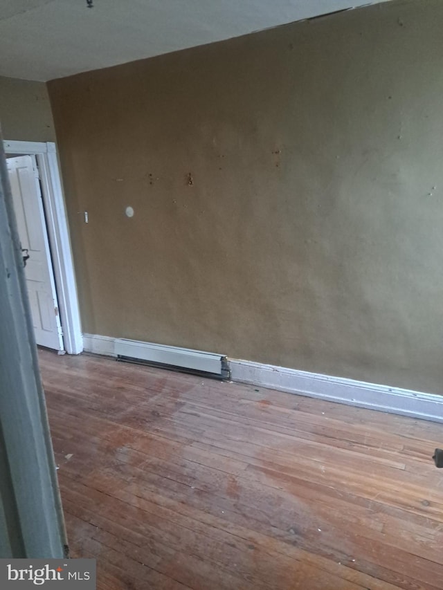 spare room featuring a baseboard radiator and light hardwood / wood-style flooring