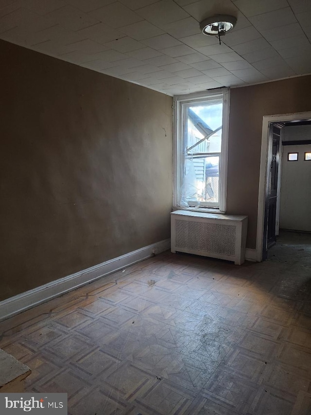 spare room featuring radiator heating unit