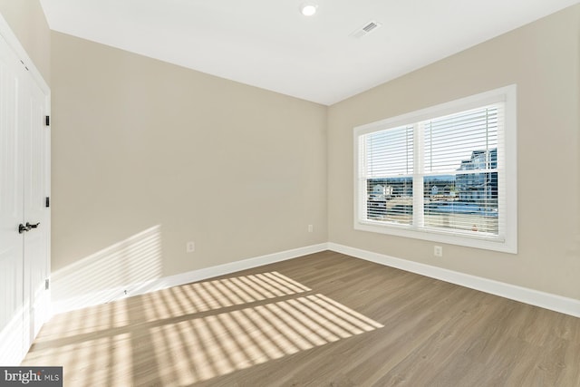 empty room with hardwood / wood-style floors